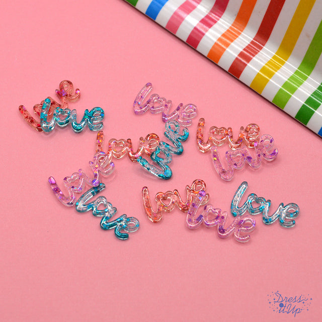 glitter transparent resin in the shape of the word, love for paper and wood crafting