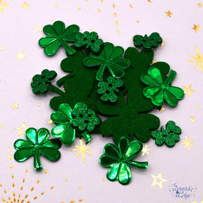 Green shamrocks in felt and shiny and glitter plastic add to St. Patrick's Day and Irish crafts