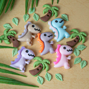 This charming pack features pastel-colored resin T. rexes paired with delicate tiny leaves and palm trees