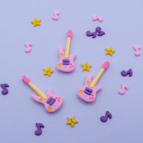 pink guitars, yellow stars, and purple music note themed craft buttons