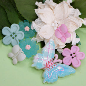 Pink, white, and blue butterfly and flower craft embellishments make perfect decorations for wood, paper, and fabric crafts