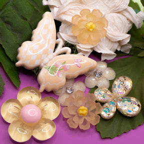 Pastel yellow butterfly and flower craft embellishments make perfect decorations for wood, paper, and fabric crafts