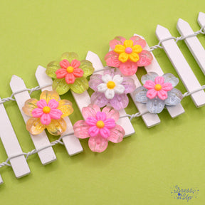 Delicate resin flowers in pastel colors, flat-back embellishments