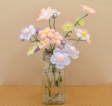craft project of a salt shaker button bouquet featuring spring resin flowers.