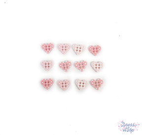Tiny 4-hole heart shaped buttons in pink add to nursery and baby crafting