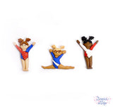 Tiny girls in red, white and blue in gymnastic poses