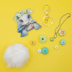 This kit includes a large acrylic turtle focal, keyring, pompom, large-hole beads, and spacers to create an adorable DIY bag or purse charm.