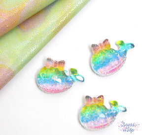 Shimmering resin whales in rainbow colors add a sweet touch to ocean and children themed projects