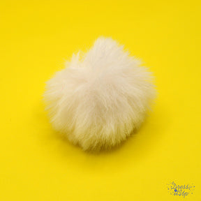 Add a white pom pom to bag charms and keychains