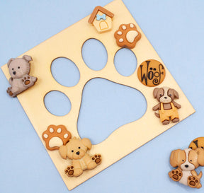Wood paw print frame with dog themed buttons and embellishments