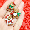 A hand holding our 3 bear button pack for scale–our 3 bear Christmas-themed buttons.