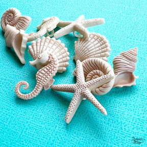 10 shank-back button embellishments pack with beachy, sand shells, starfish, conch shells, seahorses add to beach and ocean themed crafts