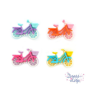 Four bright colored bike buttons for crafts