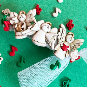 Flat-back and shank-back embellishments with 3 off white choir angels and musical notes