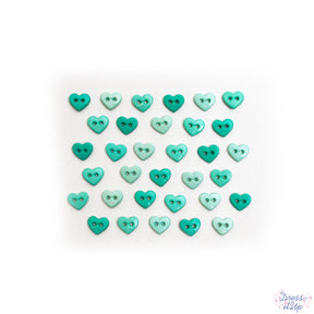 Light shades of green adorn these heart shaped sew-thru buttons for sewing and crafting